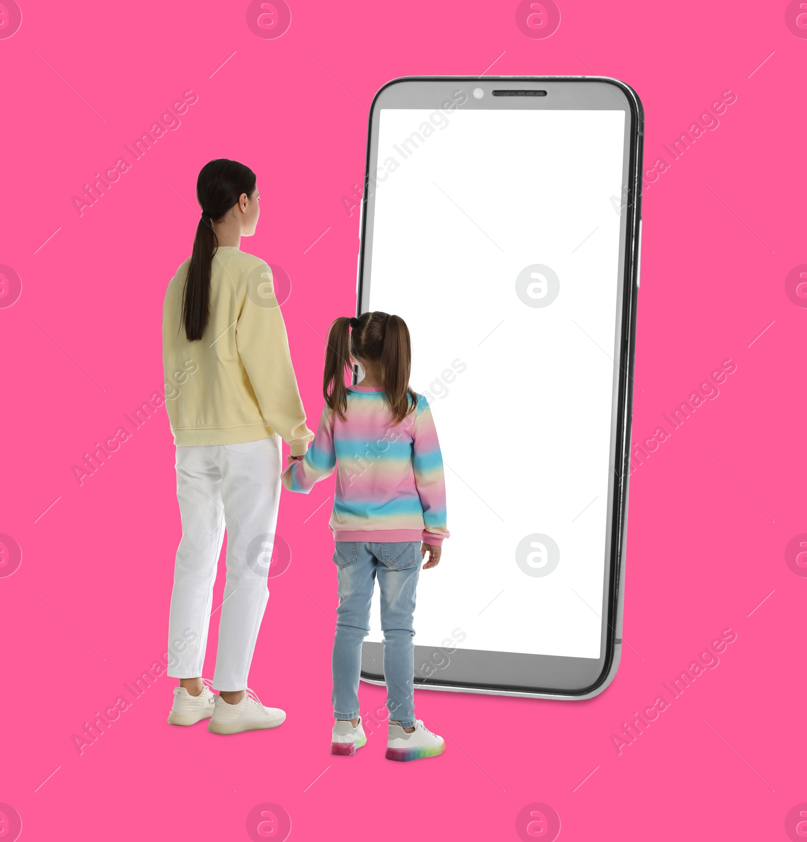 Image of Mother with her daughter standing in front of big smartphone on pink background