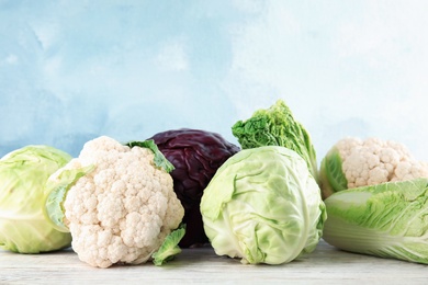 Photo of Different sorts of cabbage on wooden table