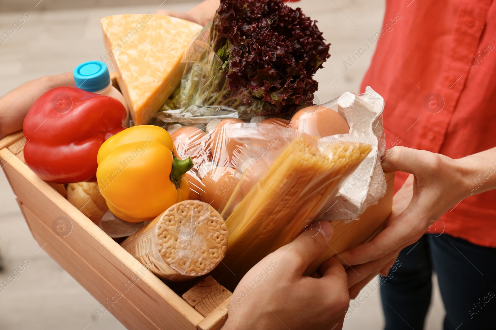 Photo of Male courier delivering food to client indoors, closeup