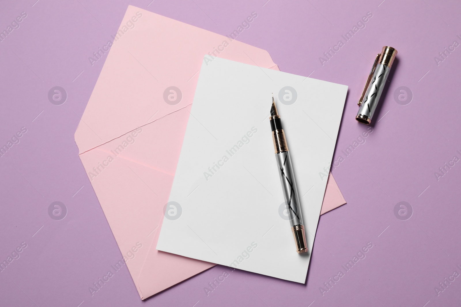 Photo of Blank sheet of paper, letter envelope and pen on violet background, top view