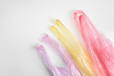 Color plastic bags isolated on white, top view