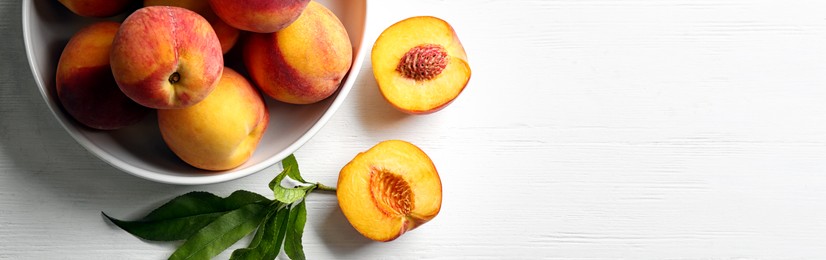 Image of Fresh ripe peaches on white wooden table, top view. Banner design with space for text