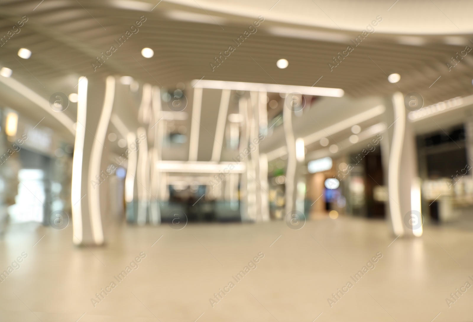 Photo of Blurred view of modern shopping mall interior. Bokeh effect
