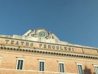 Photo of JESI, ITALY - MAY 17, 2022: Beautiful Teatro Comunale Pergolesi against blue sky, low angle view