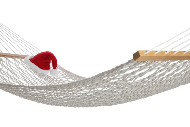 Photo of Comfortable hammock and Santa Claus hat on white background. Christmas vacation