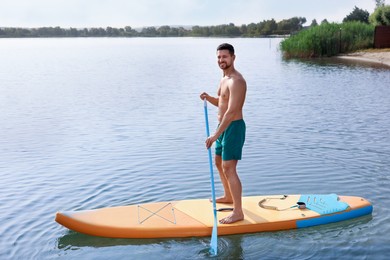 Photo of Man paddle boarding on SUP board in sea