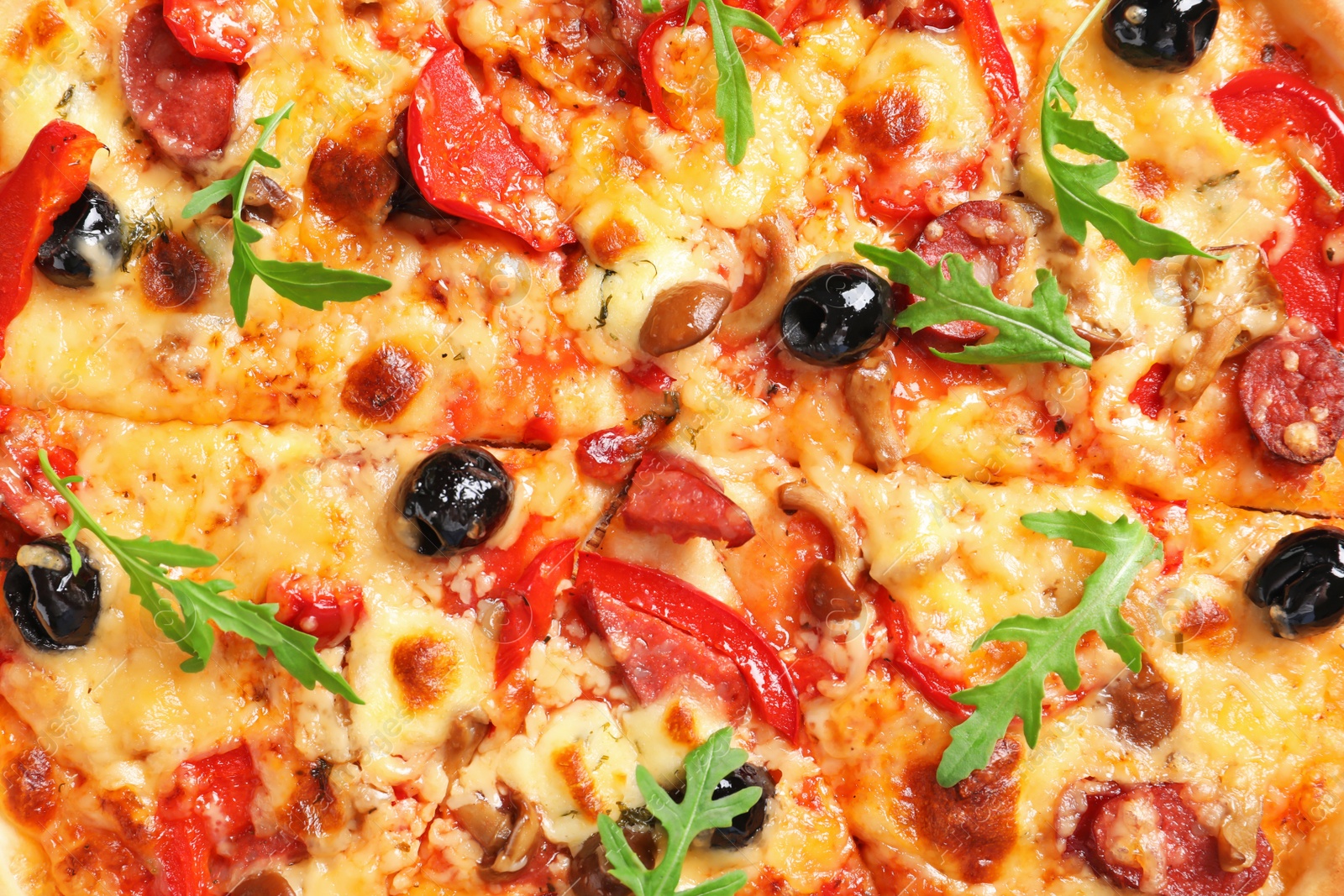 Photo of Delicious pizza with olives and sausages, closeup