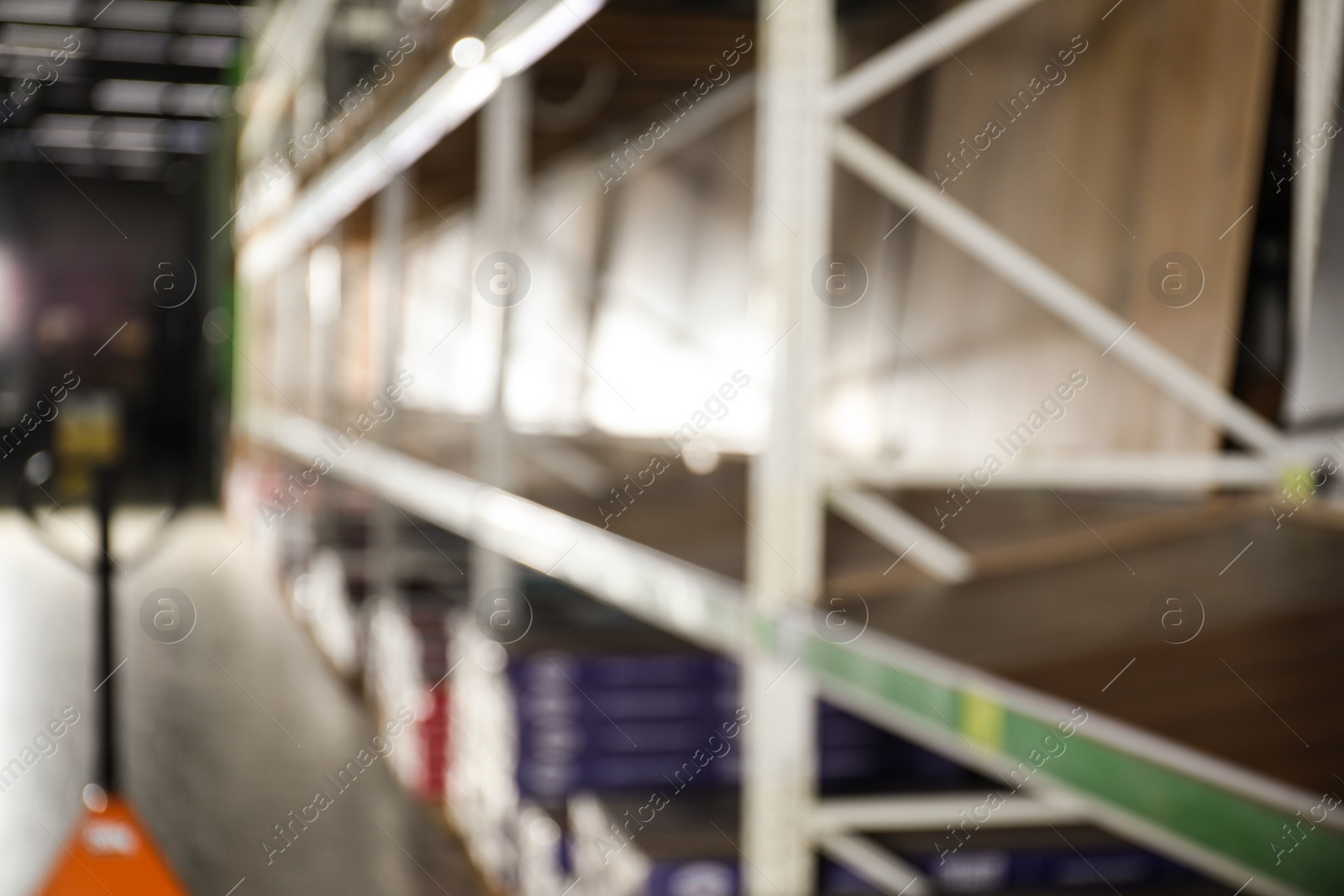 Photo of Blurred view of storage stands with different building materials in wholesale warehouse