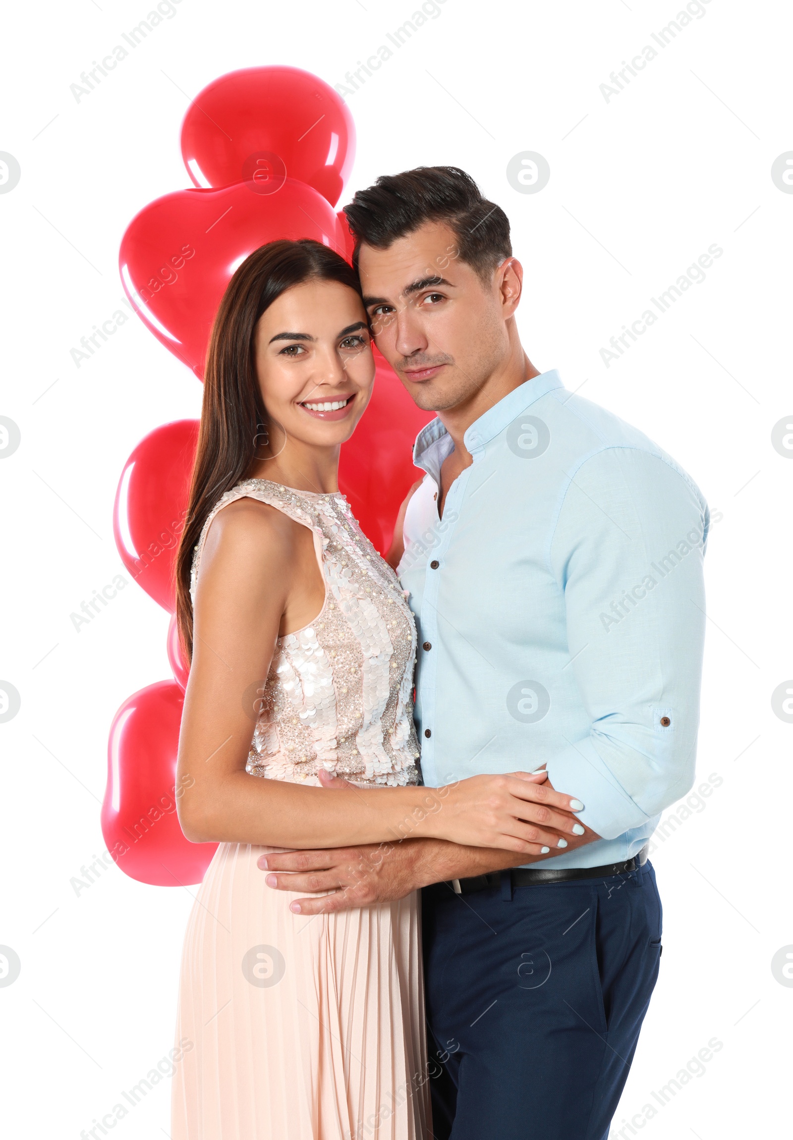 Photo of Beautiful couple with heart shaped balloons on white background