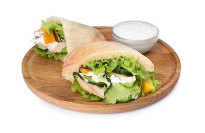 Delicious pita sandwiches with chicken breast and vegetables on white background