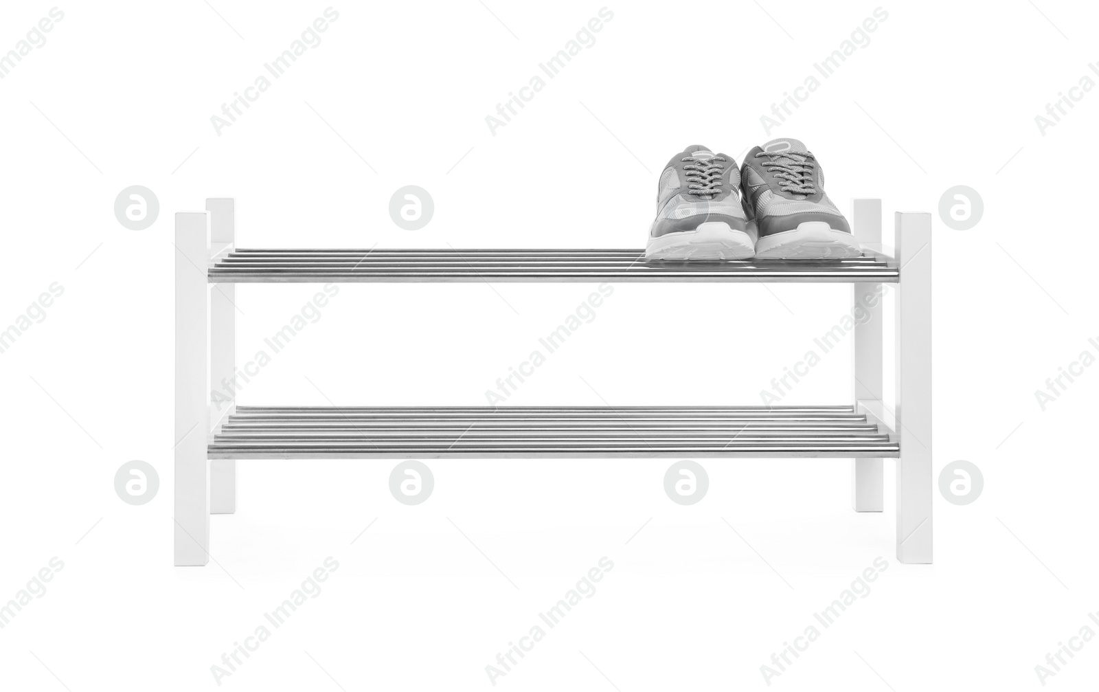 Photo of Wooden shoe shelf with sneakers isolated on white