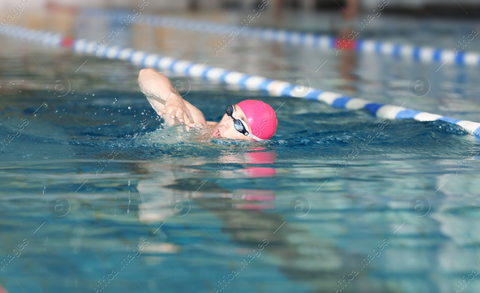 Photo of Young athletic man swimming in pool