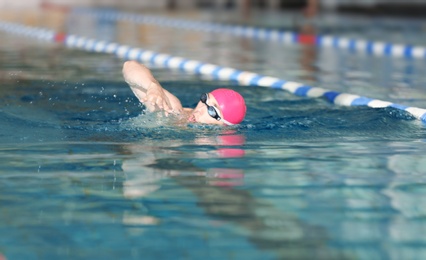 Photo of Young athletic man swimming in pool