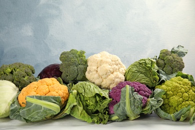 Different cabbages on wooden table. Healthy food