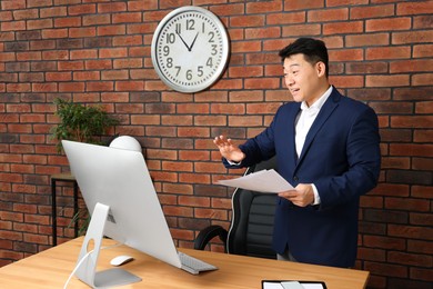 Photo of Emotional boss having online meeting in modern office