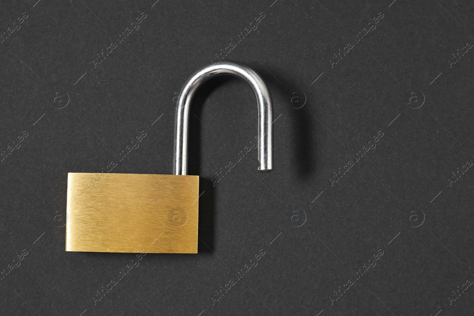 Photo of Steel padlock on black background, top view. Space for text