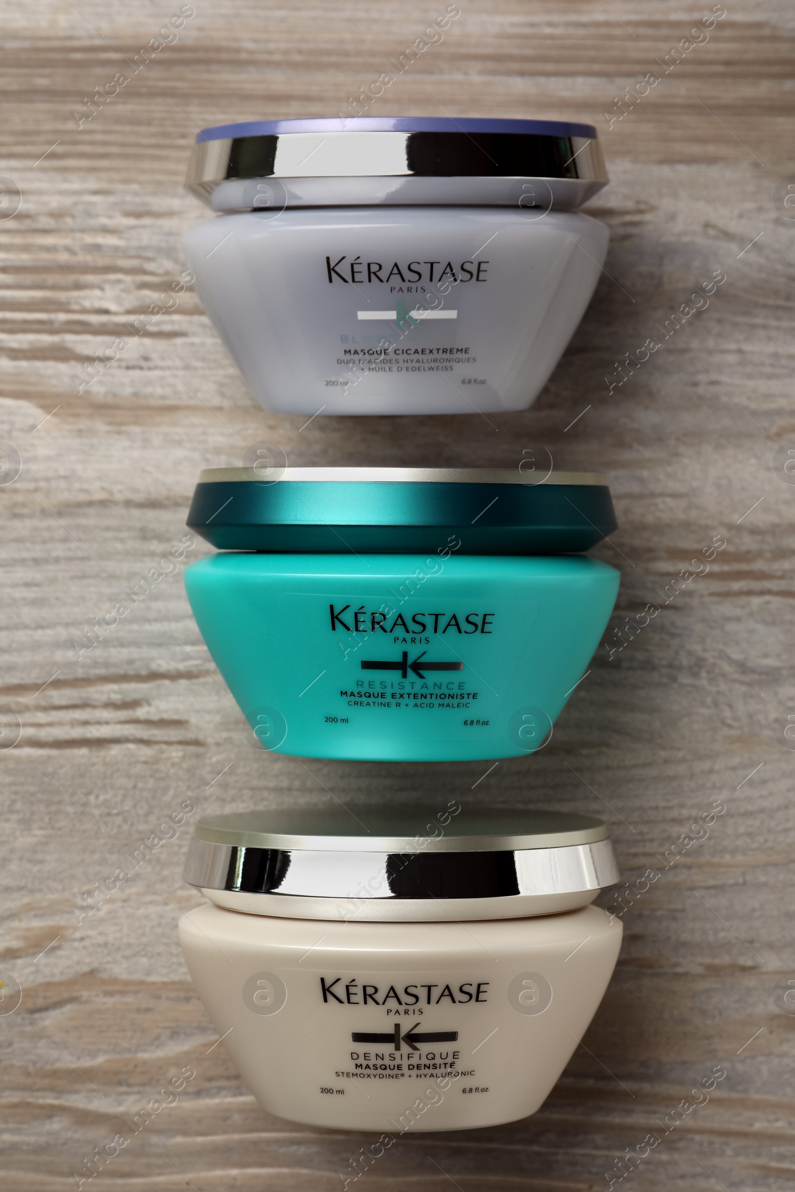 Photo of MYKOLAIV, UKRAINE - SEPTEMBER 07, 2021: Kerastase hair care masks on wooden table, flat lay