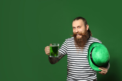 Bearded man with green beer on color background, space for text. St. Patrick's Day celebration