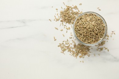 Photo of Fennel seeds in bowl on white table, top view. Space for text