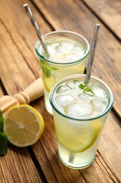 Photo of Natural lemonade with mint on wooden table. Summer refreshing drink