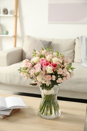 Photo of Beautiful bouquet of fresh flowers in vase on wooden table indoors