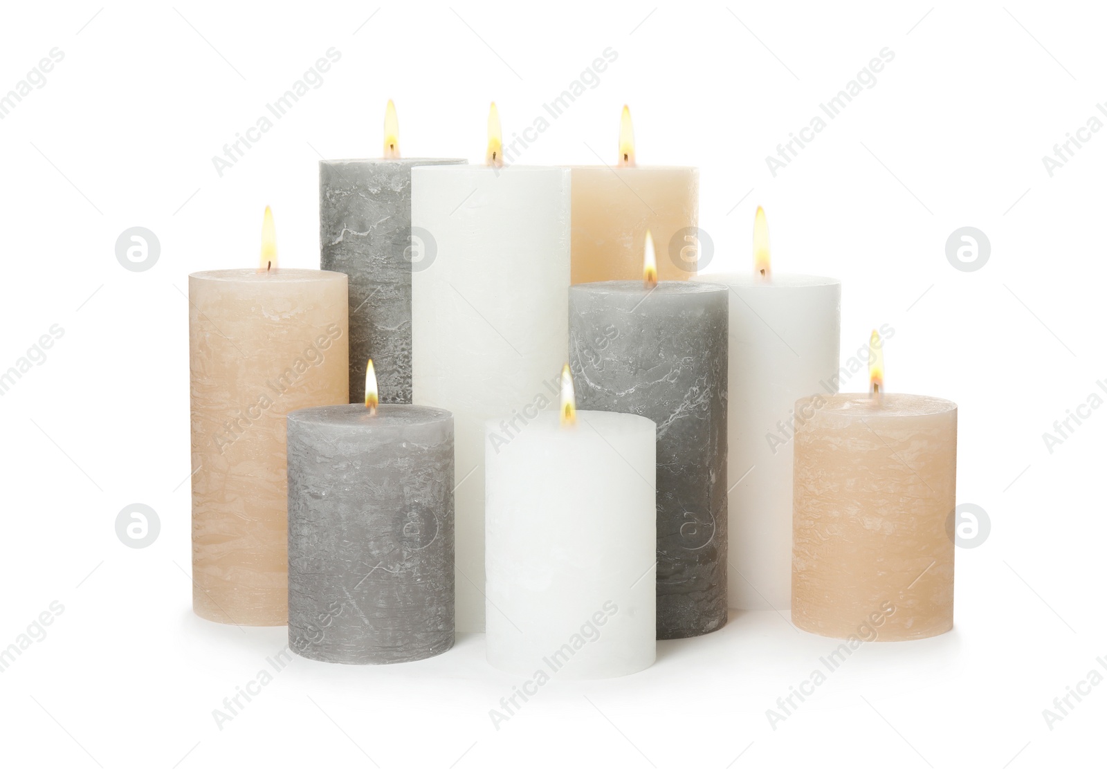 Photo of Many alight wax candles on white background