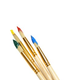 Photo of Brushes with bright paints on white background