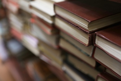 Photo of Stacks of books in library. Space for text