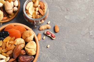 Photo of Flat lay composition of different dried fruits and nuts on color background. Space for text