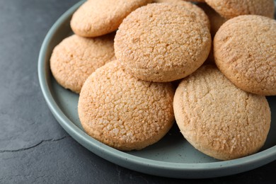 Photo of Delicious sugar cookies on black table, closeup