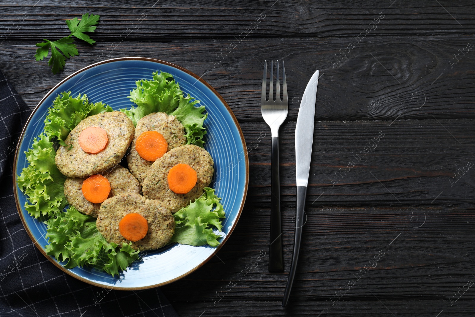 Photo of Flat lay composition with plate of traditional Passover (Pesach) gefilte fish on wooden background. Space for text