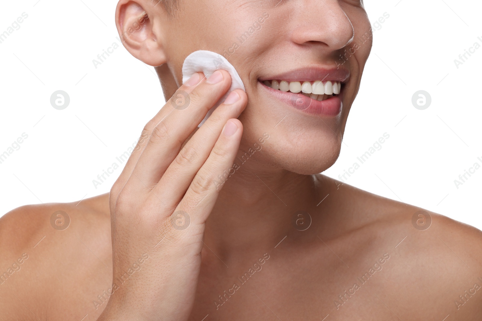 Photo of Man cleaning face with cotton pad on white background, closeup