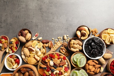 Photo of Flat lay composition of different dried fruits and nuts on color background. Space for text