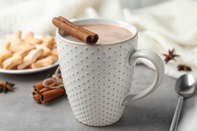 Photo of Composition with delicious cocoa drink and cookies on grey table