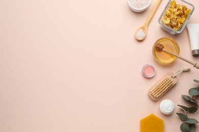 Photo of Flat lay composition with beeswax and cosmetic products on beige background. Space for text