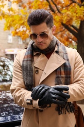 Handsome stylish man wearing black leather gloves outdoors