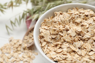 Photo of Bowl with oatmeal on table, closeup. Space for text