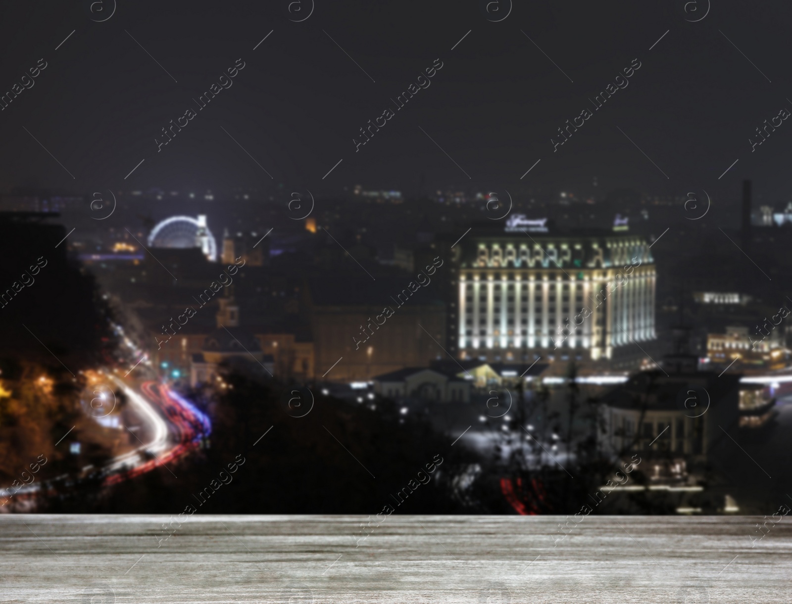 Image of Empty wooden surface and blurred view of night city