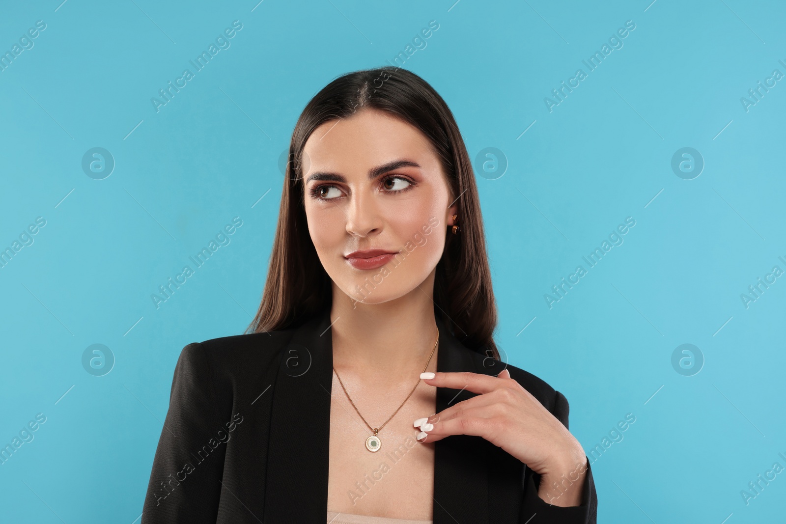 Photo of Beautiful woman with elegant necklace on light blue background