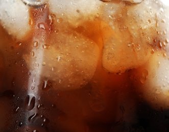 Glass of tasty refreshing cola with ice cubes, closeup