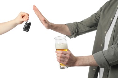 Man with glass of beer refusing drive car while woman suggesting him keys on white background, closeup. Don't drink and drive concept