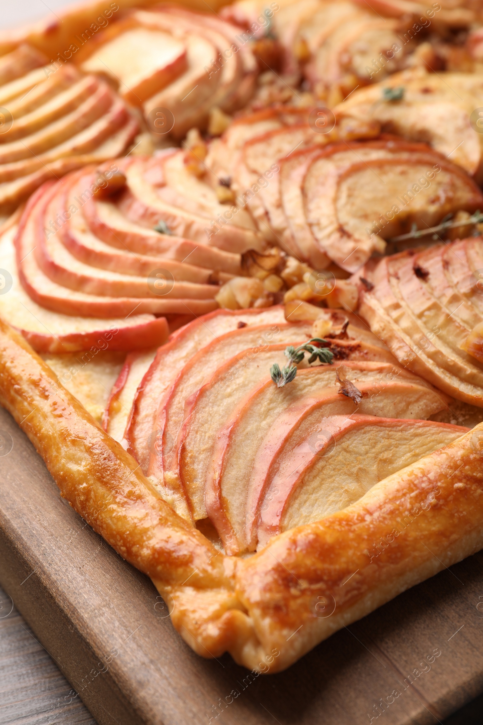Photo of Freshly baked apple pie with nuts on table, closeup