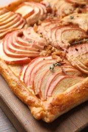 Freshly baked apple pie with nuts on table, closeup