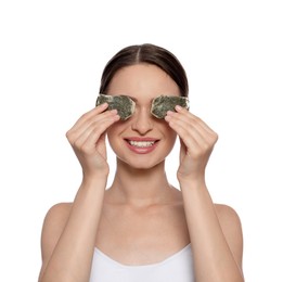 Photo of Young woman with green tea bags on white background. Eye skin care