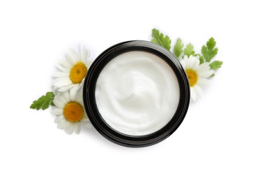 Photo of Jar of hand cream and chamomiles on white background, top view