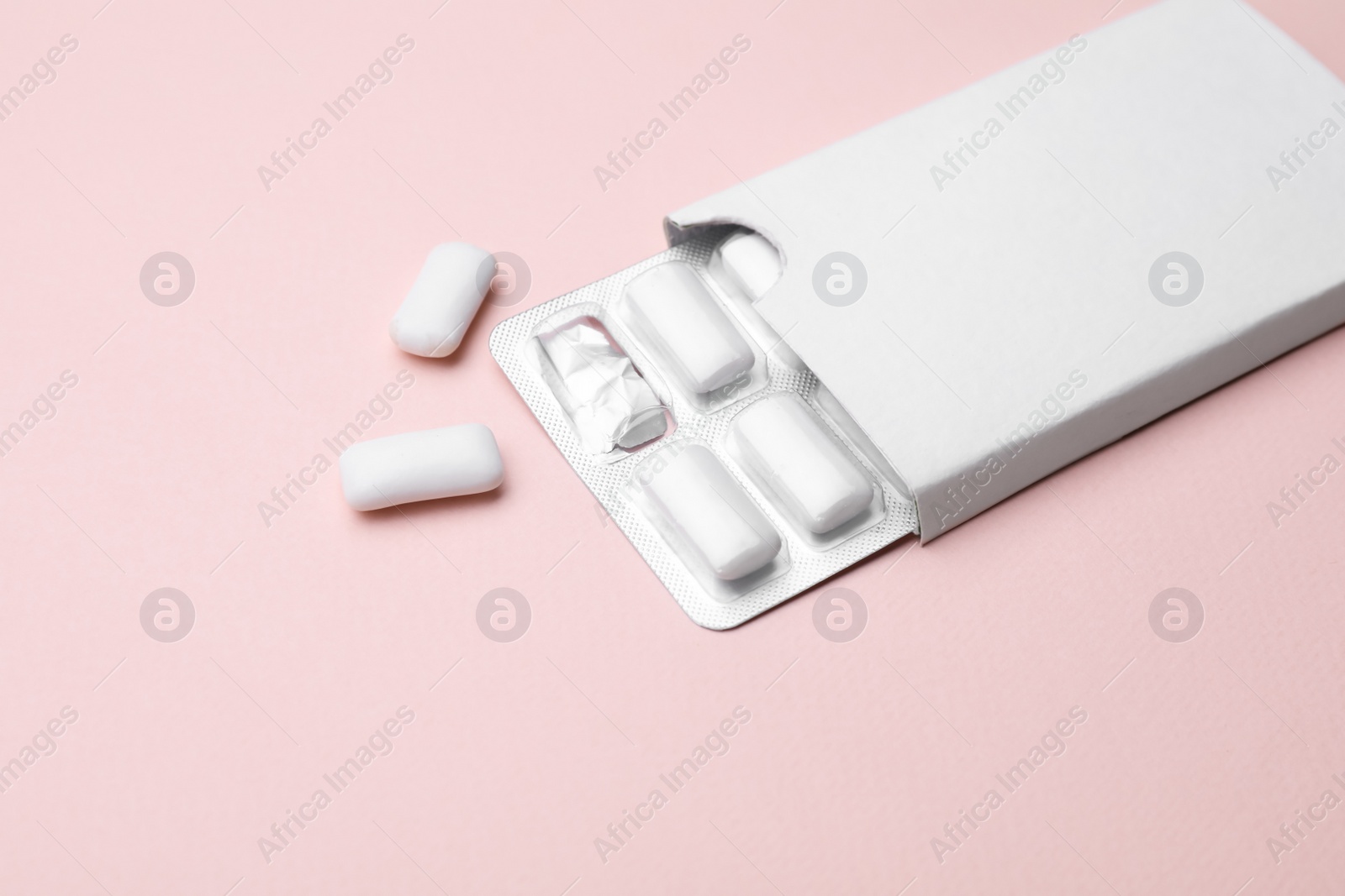 Photo of Blister with chewing gums on pink background. Space for text