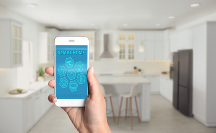 Image of Woman using home security app indoors, closeup. Space for text