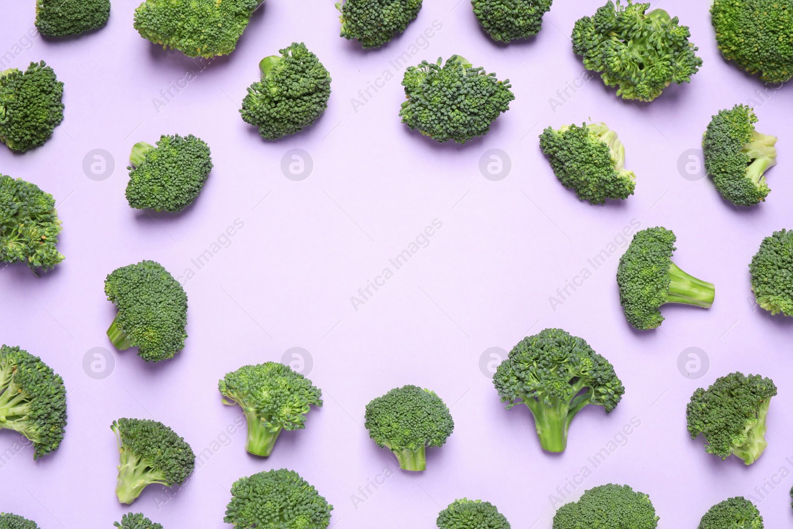 Photo of Fresh tasty broccoli on violet background, flat lay. Space for text