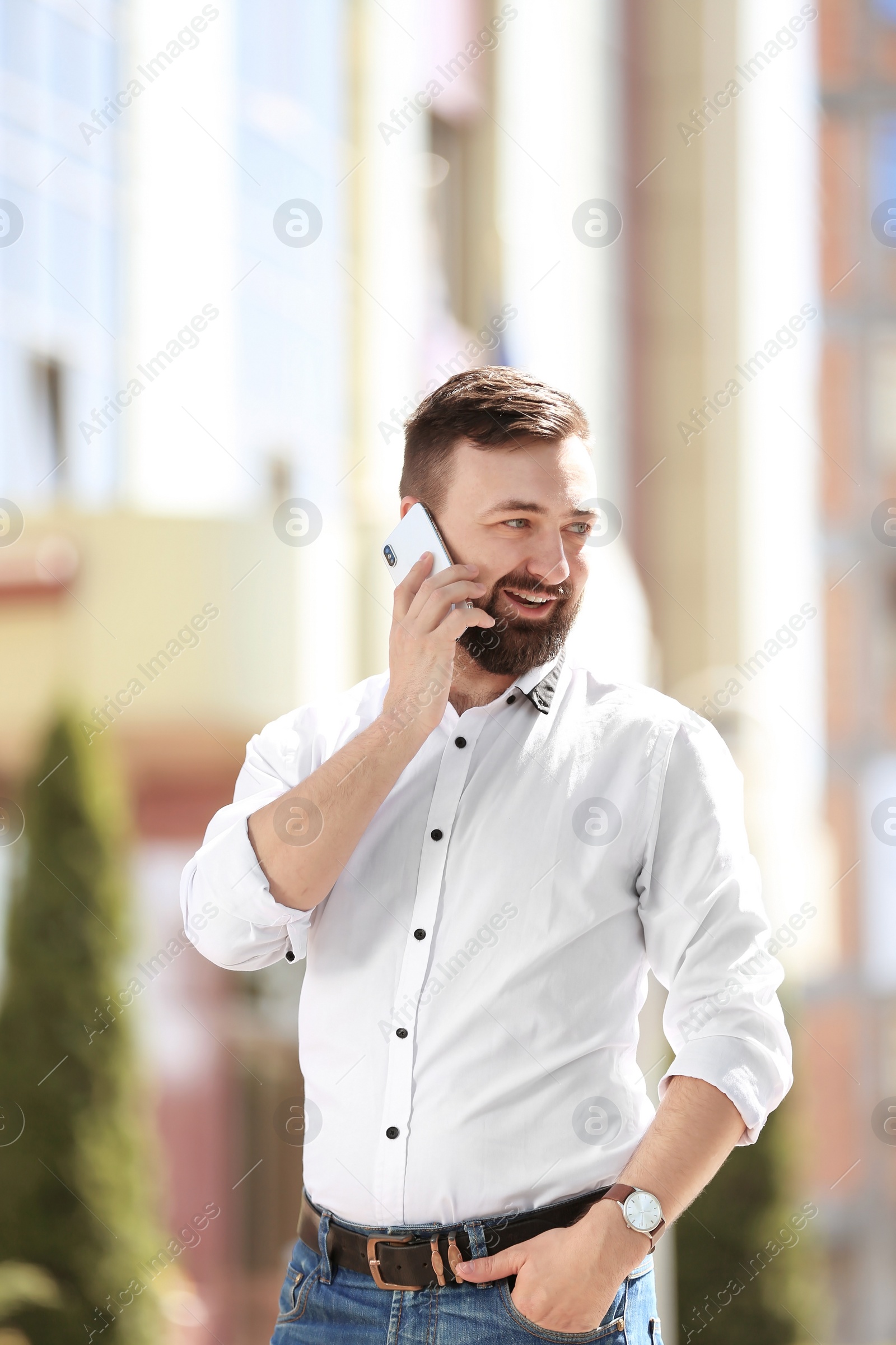 Photo of Portrait of young man talking on phone outdoors