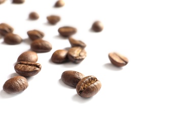 Photo of Roasted coffee beans on white background, closeup
